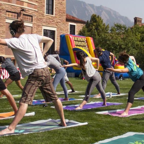 Students doing yoga outdoors